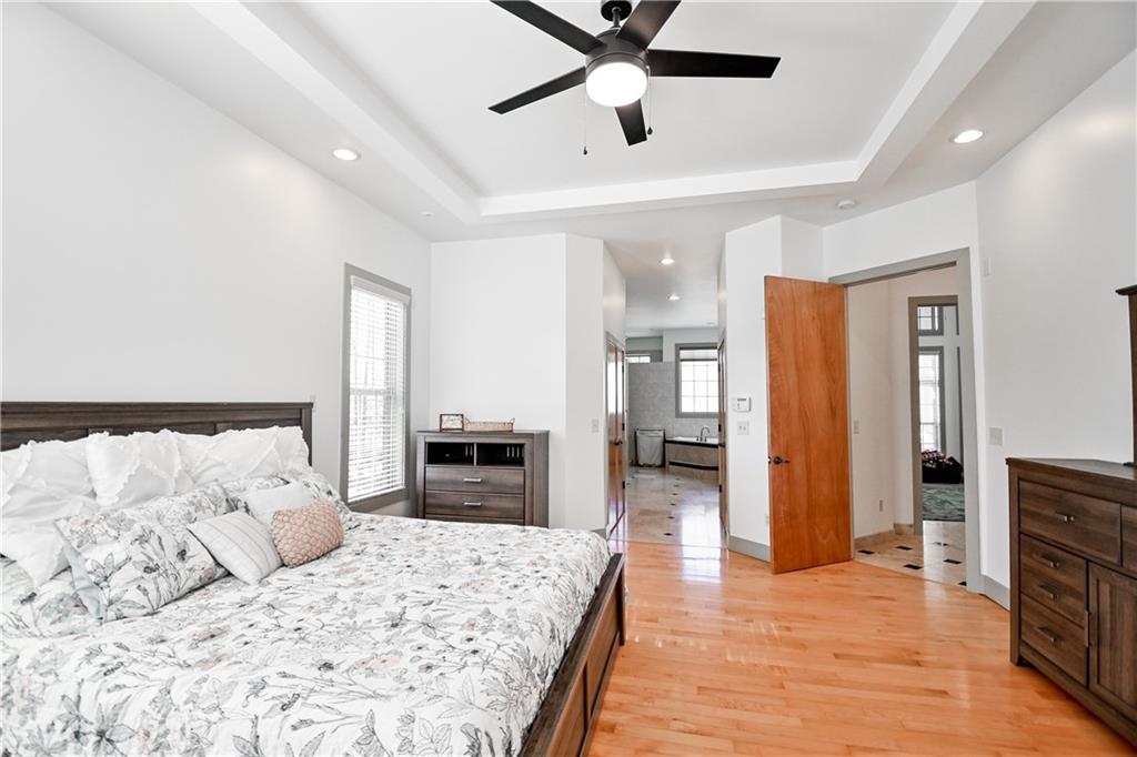 412 Trillium Trail Pendergrass, GA 30567 - Photo 18 of 37 a large bedroom with a bed closet and wooden floor