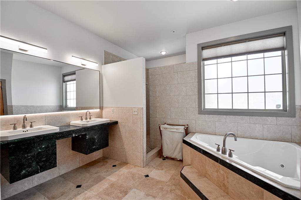 412 Trillium Trail Pendergrass, GA 30567 - Photo 22 of 37 a bathroom with a granite countertop tub a double vanity sink and a large mirror