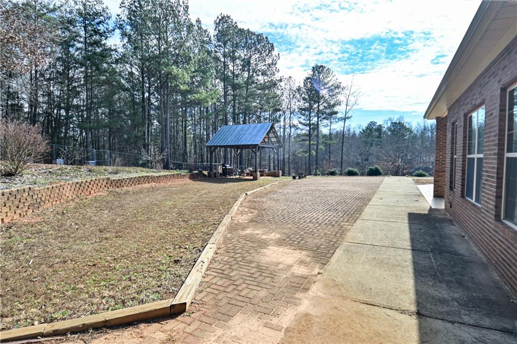 412 Trillium Trail Pendergrass, GA 30567 - Photo 30 of 37 a view of backyard with a garden and trees