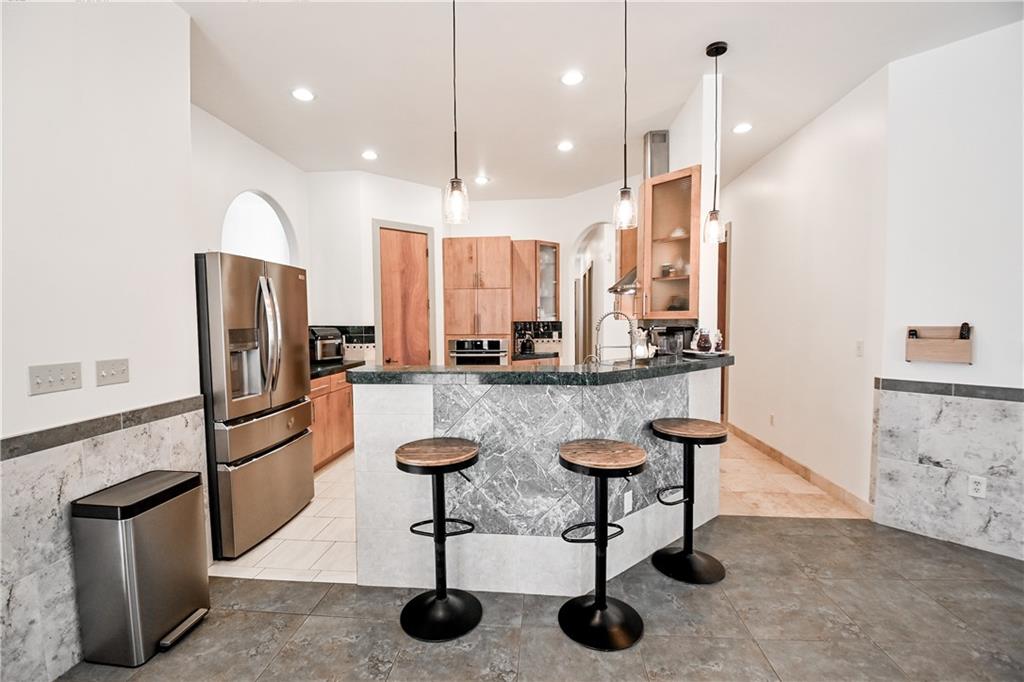412 Trillium Trail Pendergrass, GA 30567 - Photo 6 of 37 a kitchen with stainless steel appliances granite countertop a refrigerator a sink a stove a dining table and chairs with wooden floor