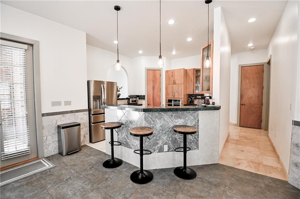 412 Trillium Trail Pendergrass, GA 30567 - Photo 9 of 49 a kitchen with stainless steel appliances kitchen island granite countertop a stove a sink and a refrigerator