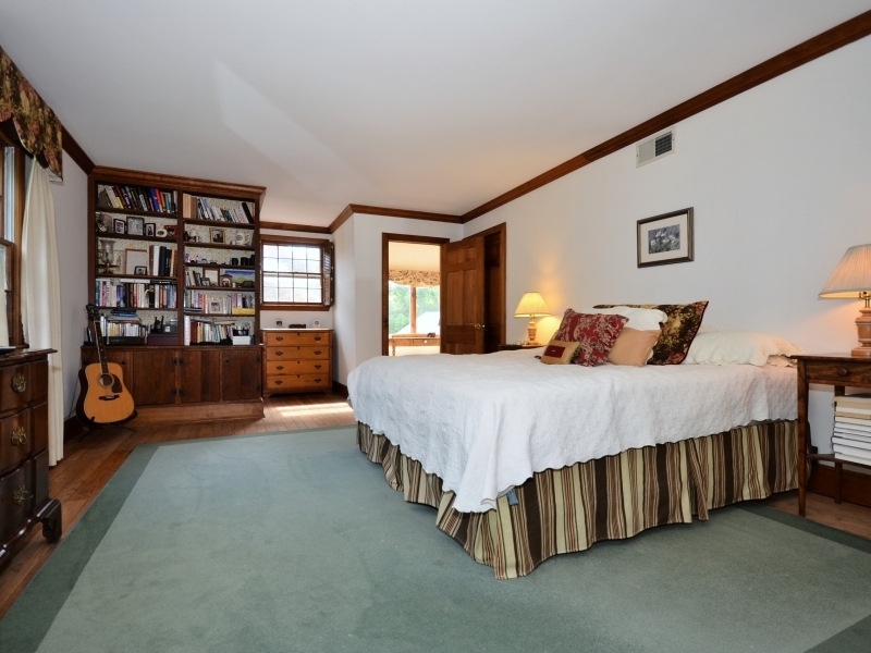 772 Ponus Ridge Road New Canaan, CT 06840 - Photo 14 of 19 a bedroom with a bed and large window