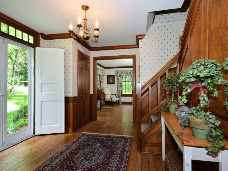 772 Ponus Ridge Road New Canaan, CT 06840 - Photo 4 of 19 a living room with furniture and a chandelier