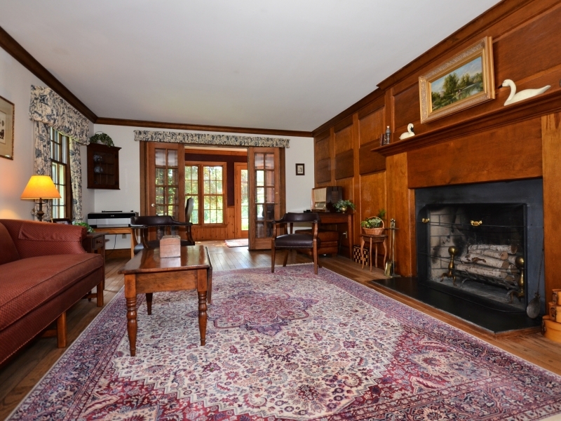 772 Ponus Ridge Road New Canaan, CT 06840 - Photo 6 of 19 a living room with furniture a fireplace and a table