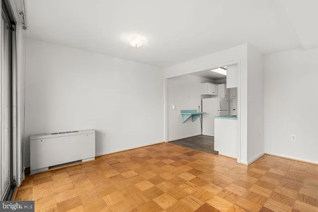 a view of empty room with wooden floor