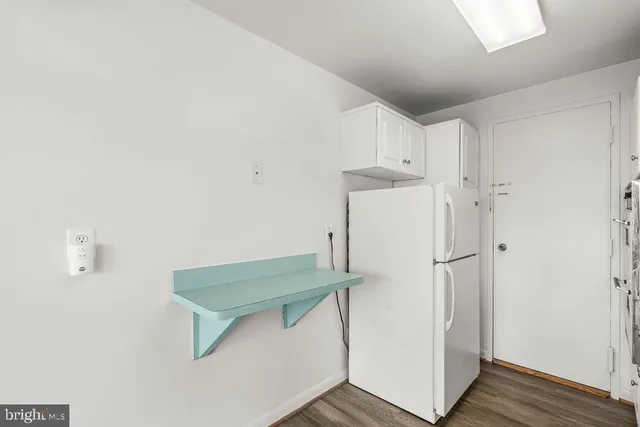 a kitchen with granite countertop a stove and a white cabinets