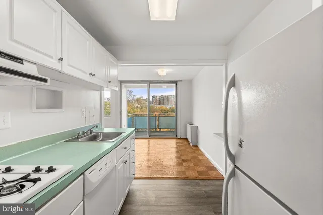 a kitchen with stainless steel appliances a stove and a refrigerator