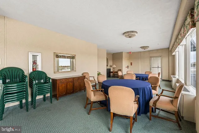 a view of a livingroom with furniture and a table chair