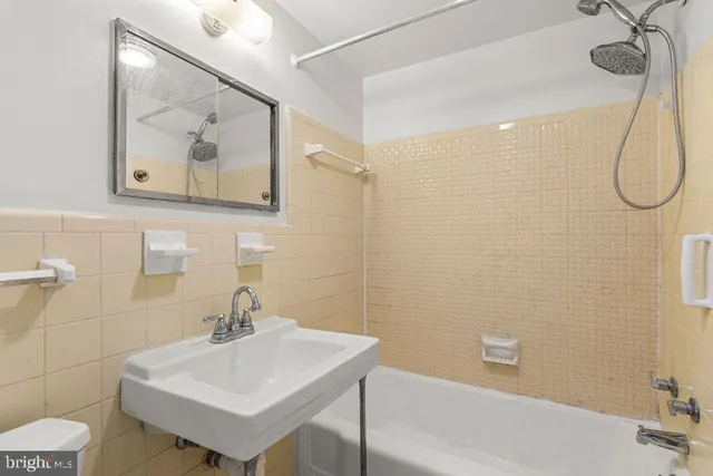 a bathroom with a sink mirror and a shower