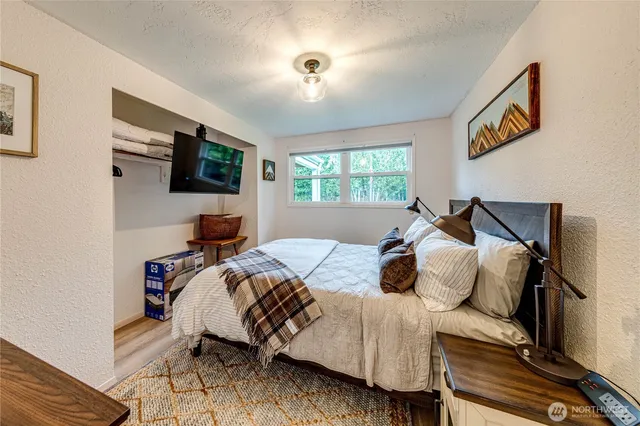 a bedroom with a bed and a flat screen tv