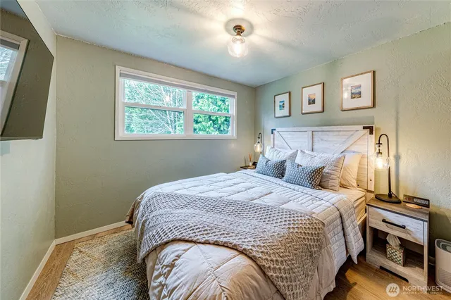 a bedroom with a bed and a window