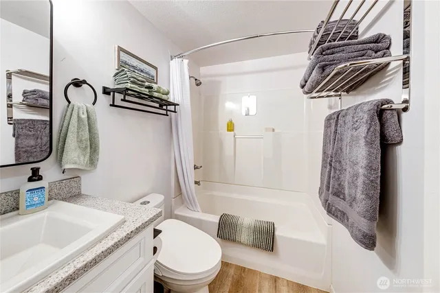 a bathroom with a sink toilet and shower