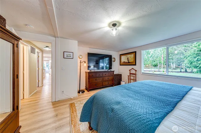 a spacious bedroom with a bed and a large window