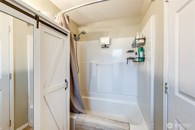 a bathroom with a shower and a tub