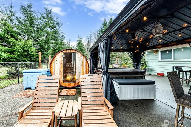 a view of a patio with table and chairs with wooden floor and fence