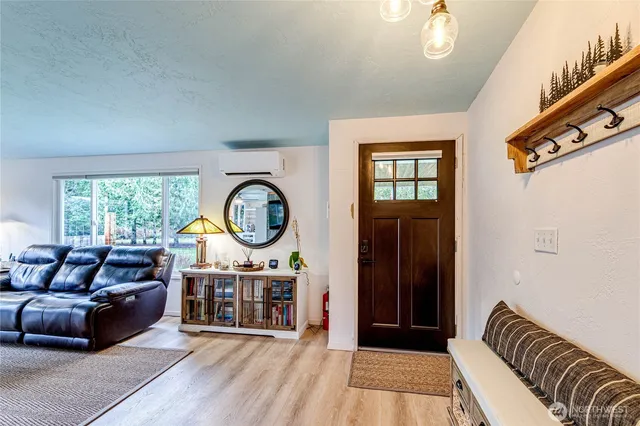 a living room with furniture a window and a chandelier