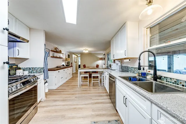 a kitchen with granite countertop lots of counter top space and stainless steel appliances