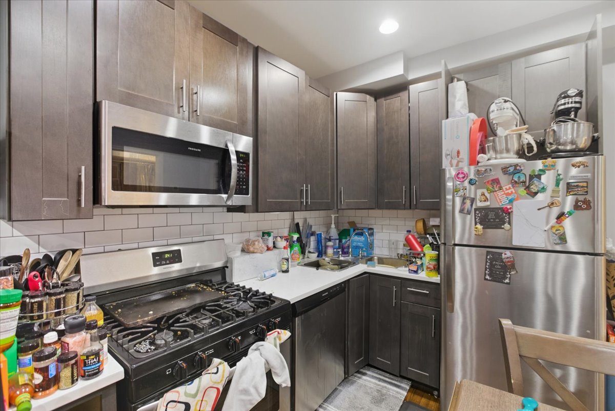 518 North May Street, Unit 1 Chicago, IL 60642 - Photo 6 of 10 a kitchen with stainless steel appliances a stove a microwave and refrigerator