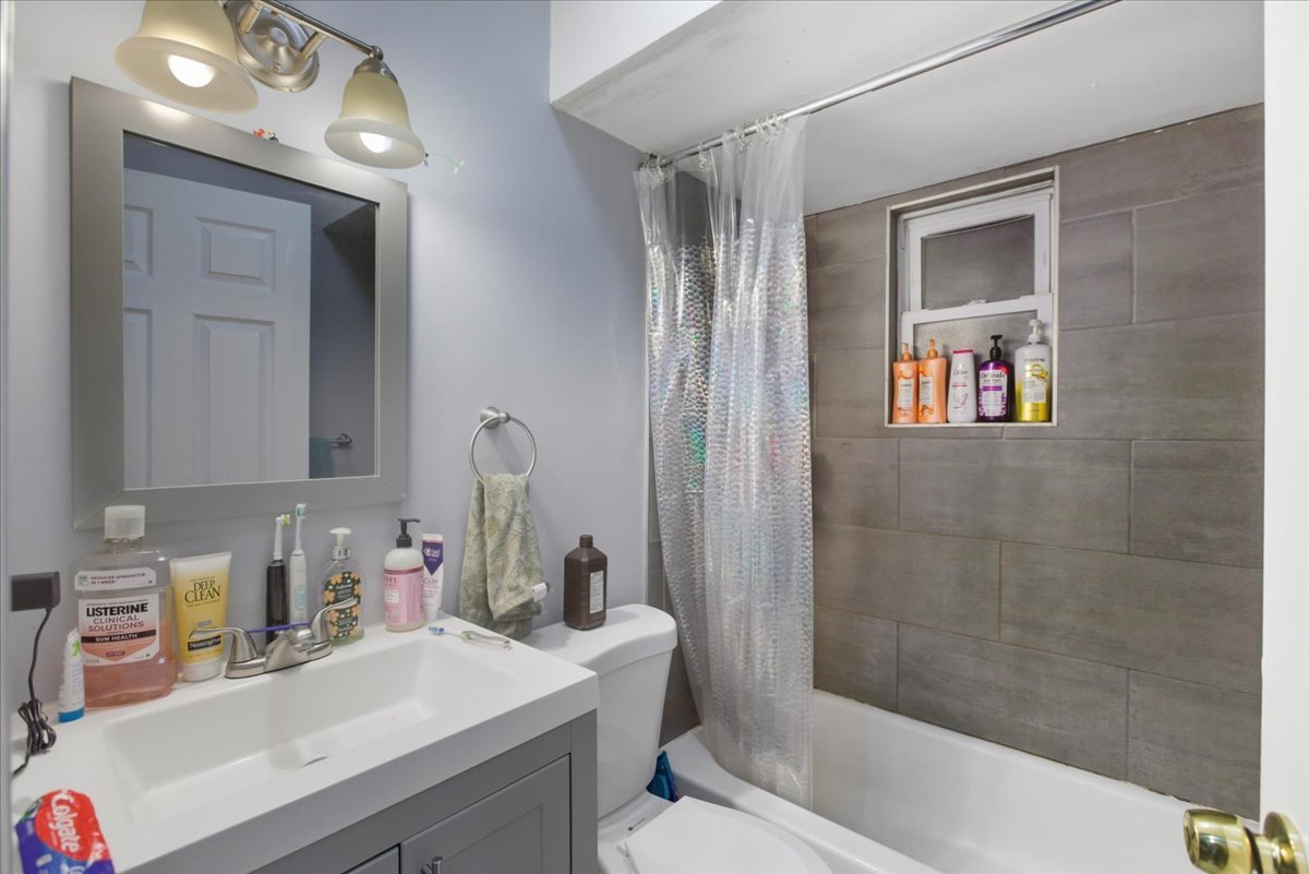 518 North May Street, Unit 1 Chicago, IL 60642 - Photo 9 of 10 a bathroom with a sink a tub and a mirror
