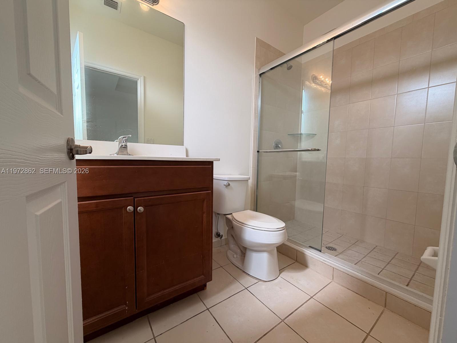 11520 Southwest 248th Lane Homestead, FL 33032 - Photo 15 of 15 a bathroom with a sink a toilet and shower