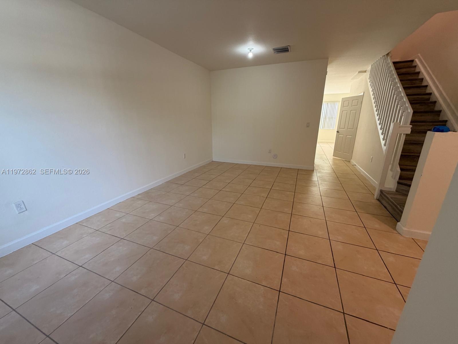 11520 Southwest 248th Lane Homestead, FL 33032 - Photo 5 of 15 a view of an empty room with wooden floor