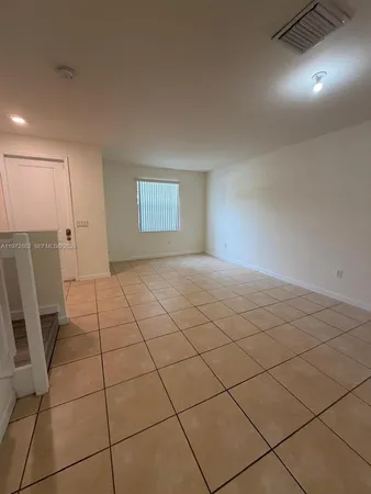 a view of a livingroom and window