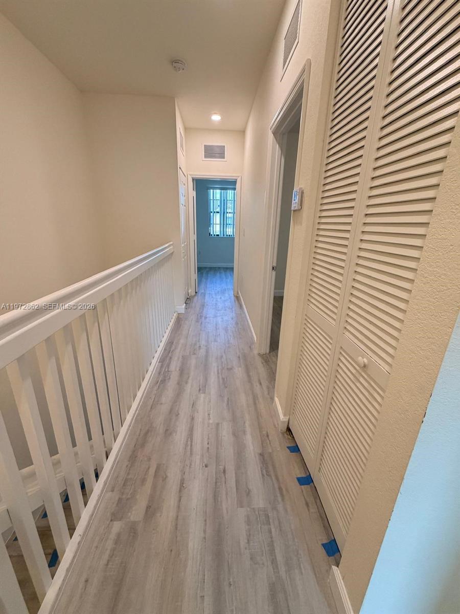 11520 Southwest 248th Lane Homestead, FL 33032 - Photo 7 of 15 a view of a hallway with wooden floor
