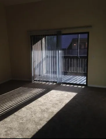 a view of wooden floor and windows in a room
