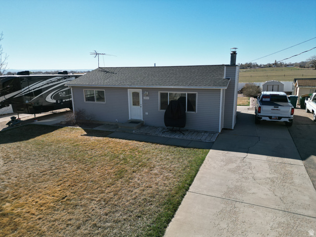 1852 East 3500th Street South Vernal, UT 84078 - Photo 29 of 46 Ranch-style home featuring a shingled roof, a front lawn, and driveway