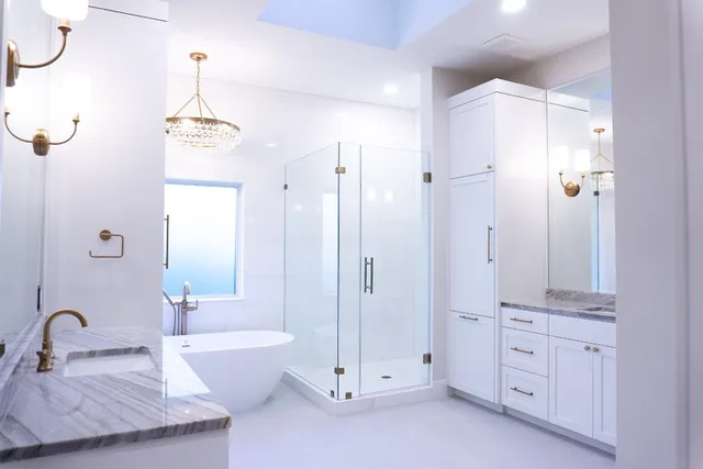 a bathroom with a double vanity sink toilet and shower
