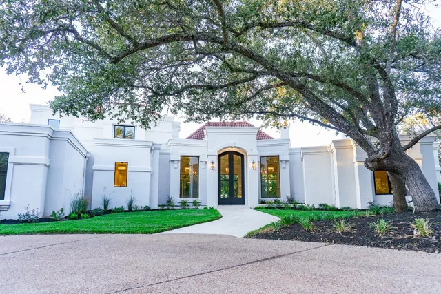 a front view of a house with garden