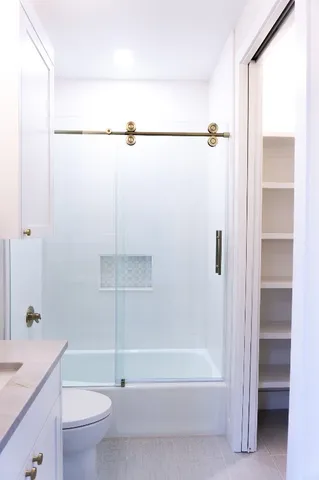 a bathroom with a bathtub a toilet and a shower