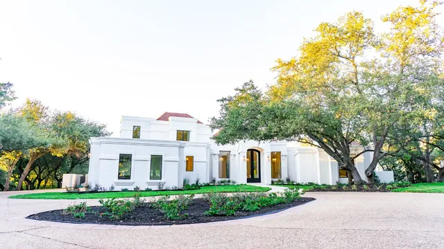 a front view of a house with a garden