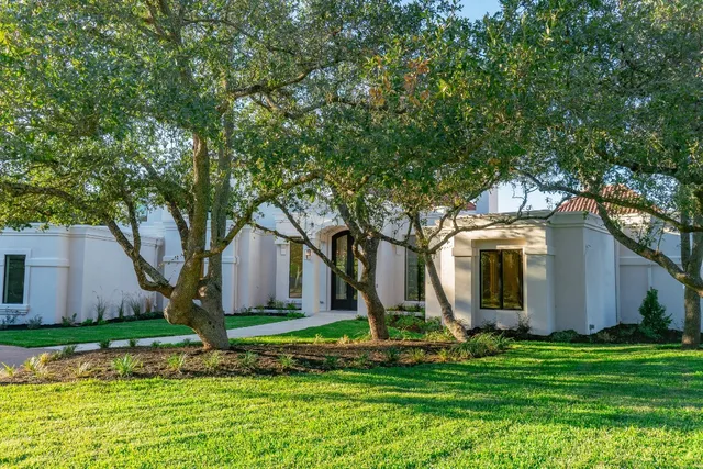 a front view of house with yard and green space
