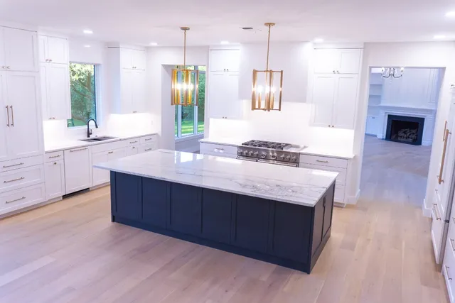 a bathroom with a granite countertop sink a large mirror and shower