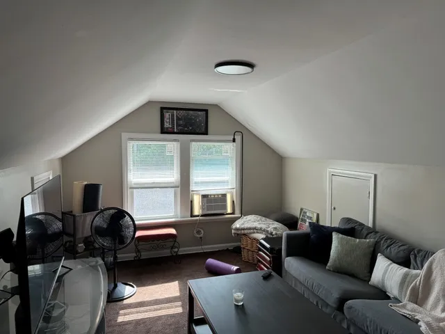a living room with furniture a couch and windows
