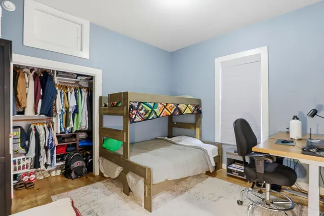 a bedroom with a bed and a desk