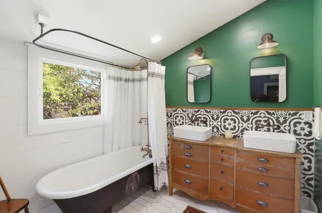 a bathroom with a sink mirror and a bathtub