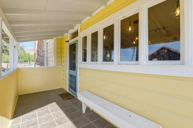 a view of a balcony with wooden floor and a table
