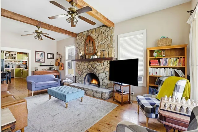 a living room with furniture fireplace and a flat screen tv