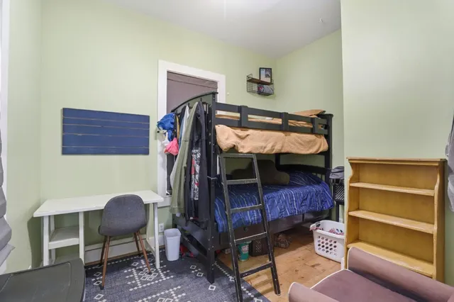 a bedroom with a bunk bed and a chair