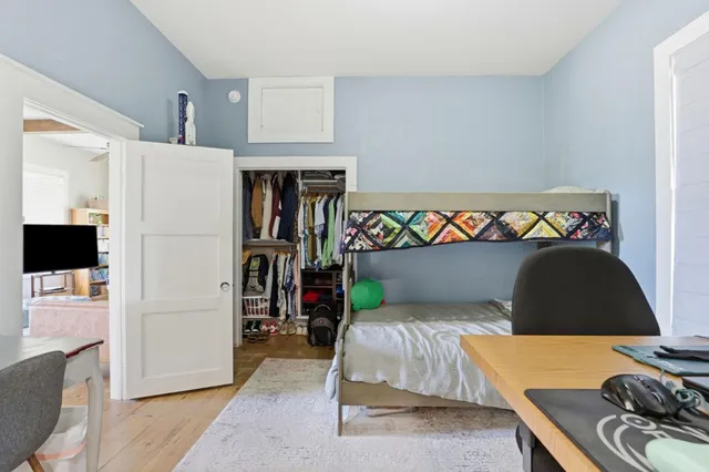 a bedroom with a bed and a couch