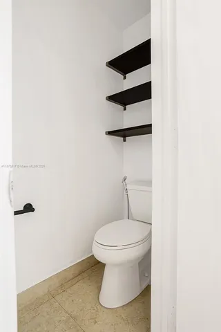 a bathroom with a toilet and a vanity