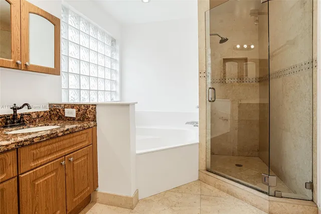 a bathroom with a shower sink and mirror