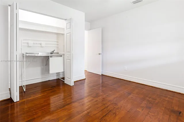 an empty room with wooden floor