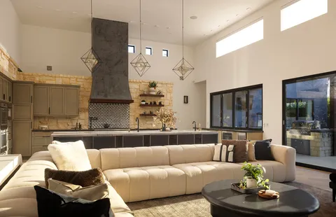 a living room with furniture and a chandelier