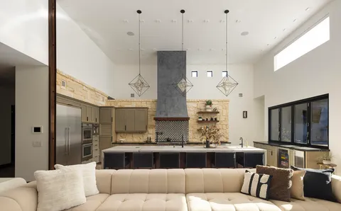 a living room with furniture and a floor to ceiling window
