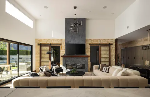 a living room with stainless steel appliances kitchen island a fireplace and a view of living room