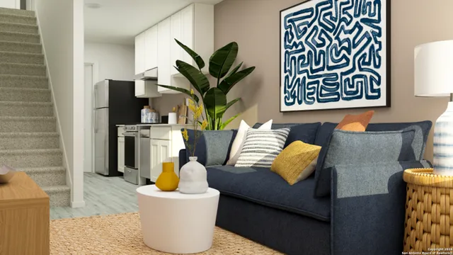 a living room with furniture and a potted plant