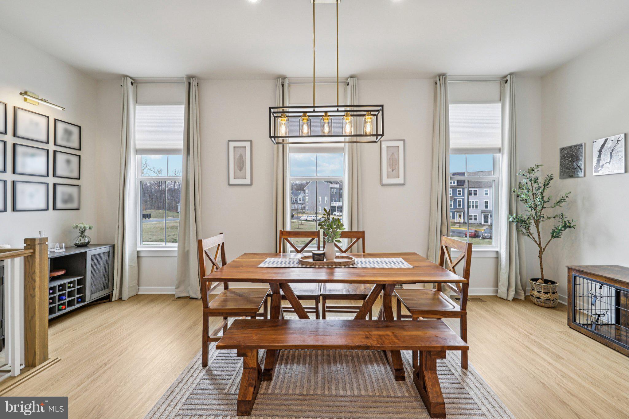 1687 Aspen Poplar Road Dumfries, VA 22026 - Photo 11 of 69 a dining room with wooden floor a chandelier a wooden table and chairs